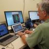 Man types information into a computer.
